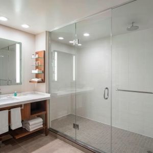 Guest bathroom with shower and free toiletries at Delta Hotel By Marriott Regina.