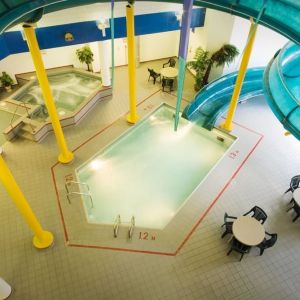 Indoor pool with spiral slide and jacuzzi at Delta Hotel By Marriott Regina.