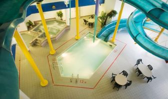 Indoor pool with spiral slide and jacuzzi at Delta Hotel By Marriott Regina.