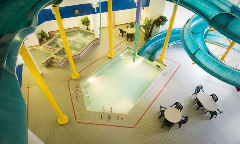 Indoor pool with spiral slide and jacuzzi at Delta Hotel By Marriott Regina.