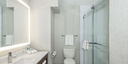 Guest bathroom with shower and free toiletries at Holiday Inn Express & Suites Medicine Hat.