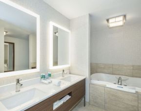 Guest bathroom with tub and free toiletries at Holiday Inn Express & Suites Medicine Hat.