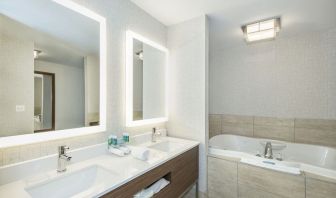 Guest bathroom with tub and free toiletries at Holiday Inn Express & Suites Medicine Hat.