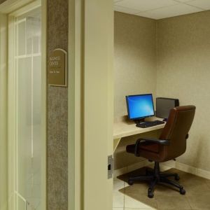 Business center with computer, printer and ergonomic chair at Holiday Inn Express & Suites Medicine Hat.