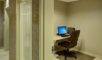 Business center with computer, printer and ergonomic chair at Holiday Inn Express & Suites Medicine Hat.