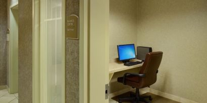 Business center with computer, printer and ergonomic chair at Holiday Inn Express & Suites Medicine Hat.