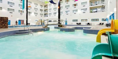 Indoor pool with water slides at Holiday Inn Lethbridge. 