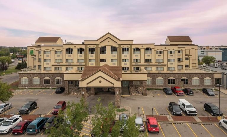 Hotel exterior with parking area at Holiday Inn Lethbridge. 