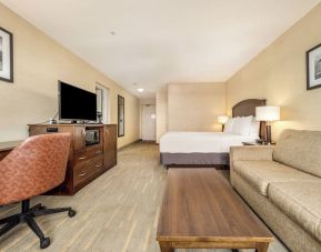 Day use room with TV, work desk and living area at Holiday Inn Lethbridge. 