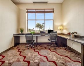 Business center with computer, printer and ergonomic chair at Holiday Inn Lethbridge. 