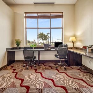 Business center with computer, printer and ergonomic chair at Holiday Inn Lethbridge. 