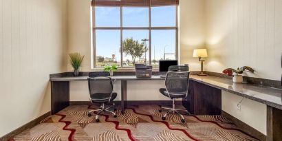 Business center with computer, printer and ergonomic chair at Holiday Inn Lethbridge. 