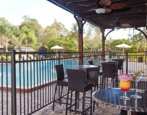 Outdoor seats beside the pool at Holiday Inn Orlando SW - Celebration Area.