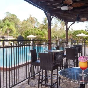 Outdoor seats beside the pool at Holiday Inn Orlando SW - Celebration Area.