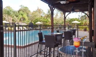 Outdoor seats beside the pool at Holiday Inn Orlando SW - Celebration Area.