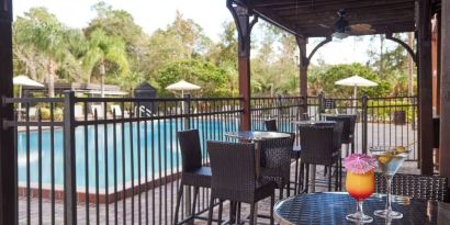 Outdoor seats beside the pool at Holiday Inn Orlando SW - Celebration Area.