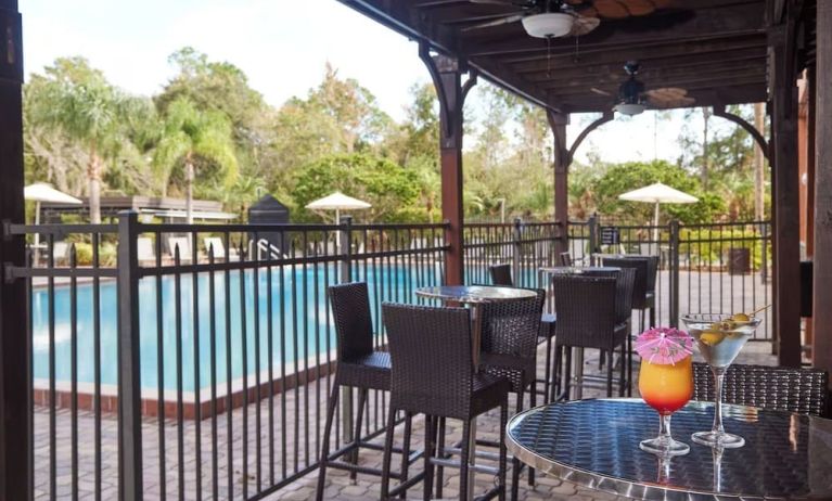 Outdoor seats beside the pool at Holiday Inn Orlando SW - Celebration Area.