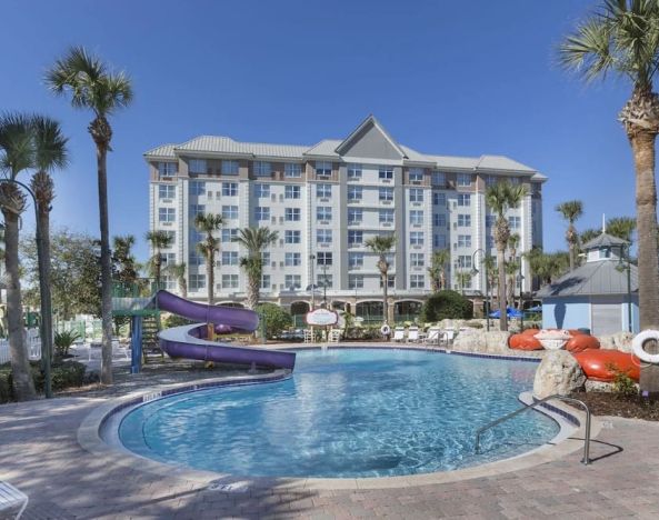 Refreshing outdoor pool with slide at Holiday Inn Express & Suites S Lake Buena Vista.