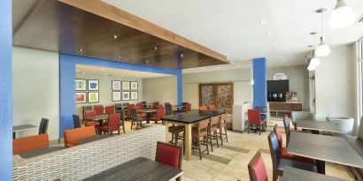 Dining area perfect for coworking at Holiday Inn Express & Suites S Lake Buena Vista.