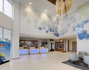 Lobby and coworking lounge at Holiday Inn Express & Suites S Lake Buena Vista.