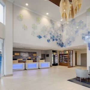 Lobby and coworking lounge at Holiday Inn Express & Suites S Lake Buena Vista.