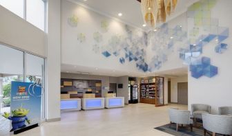 Lobby and coworking lounge at Holiday Inn Express & Suites S Lake Buena Vista.