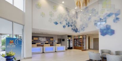 Lobby and coworking lounge at Holiday Inn Express & Suites S Lake Buena Vista.