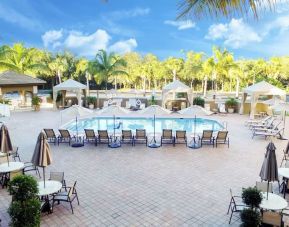 Sun loungers surrounding the pool at Holiday Inn Express & Suites Naples Downtown - 5th Avenue.