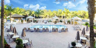 Sun loungers surrounding the pool at Holiday Inn Express & Suites Naples Downtown - 5th Avenue.