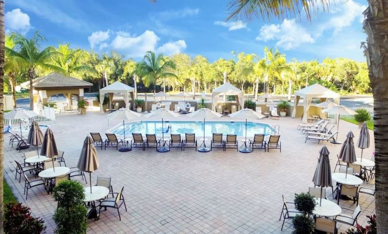 Sun loungers surrounding the pool at Holiday Inn Express & Suites Naples Downtown - 5th Avenue.