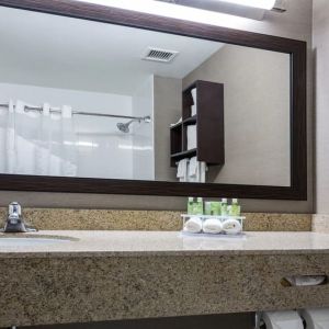 Guest bathroom with shower at Holiday Inn Express & Suites Naples Downtown - 5th Avenue.