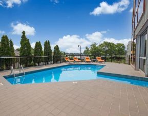 Hotel terrace with outdoor pool and lounge chairs at Holiday Inn Peterborough-Waterfront.