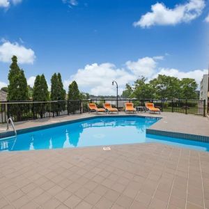 Hotel terrace with outdoor pool and lounge chairs at Holiday Inn Peterborough-Waterfront.