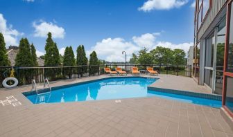 Hotel terrace with outdoor pool and lounge chairs at Holiday Inn Peterborough-Waterfront.