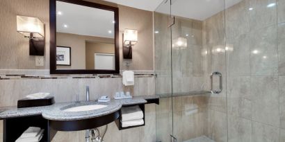 Guest bathroom with shower at Holiday Inn Peterborough-Waterfront.