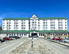 Hotel exterior and parking area at Divya Sutra Plaza & Conference Centre.