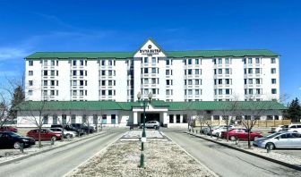 Hotel exterior and parking area at Divya Sutra Plaza & Conference Centre.