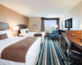 Day use twin room with work desk, TV and sofa at Best Western Plus Winnipeg Airport.