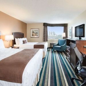 Day use twin room with work desk, TV and sofa at Best Western Plus Winnipeg Airport.