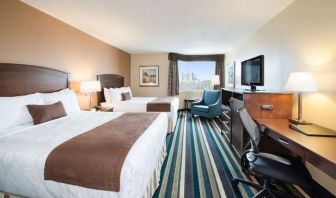 Day use twin room with work desk, TV and sofa at Best Western Plus Winnipeg Airport.