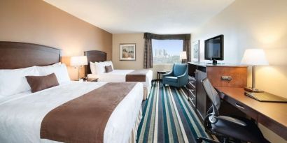 Day use twin room with work desk, TV and sofa at Best Western Plus Winnipeg Airport.