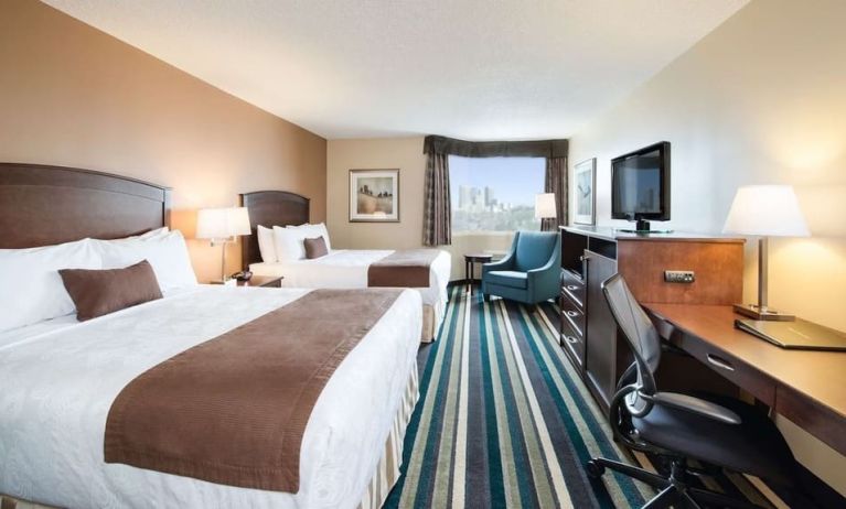 Day use twin room with work desk, TV and sofa at Best Western Plus Winnipeg Airport.