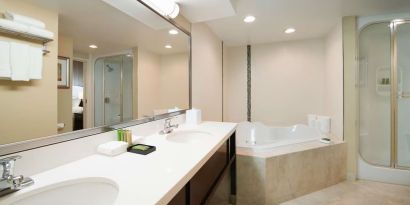 Suite's guest bathroom with hot tub at Best Western Plus Winnipeg Airport.