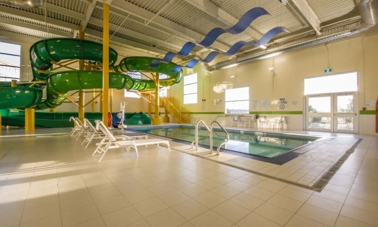 Indoor heated pool with lounge chairs and waterslides at Holiday Inn St. John's Conference Centre.