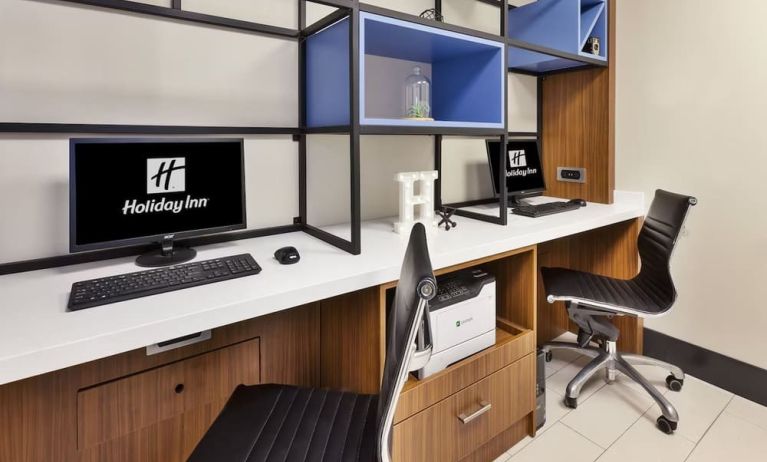 Business center with computers, printer and ergonomic chairs at Holiday Inn St. John's Conference Centre.