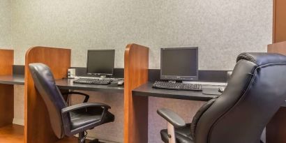 Business center with computers, printer and ergonomic chairs at Quality Inn Hotel Medicine Hat.