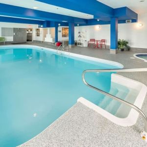 Indoor heated pool with lounge chairs at Quality Inn Hotel Medicine Hat.