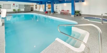 Indoor heated pool with lounge chairs at Quality Inn Hotel Medicine Hat.