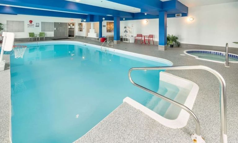 Indoor heated pool with lounge chairs at Quality Inn Hotel Medicine Hat.