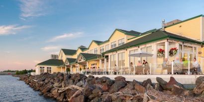 Beautiful hotel terrace with dining area at Rodd Miramichi River.